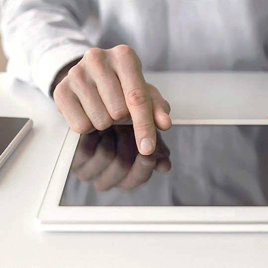 man signing on tablet
