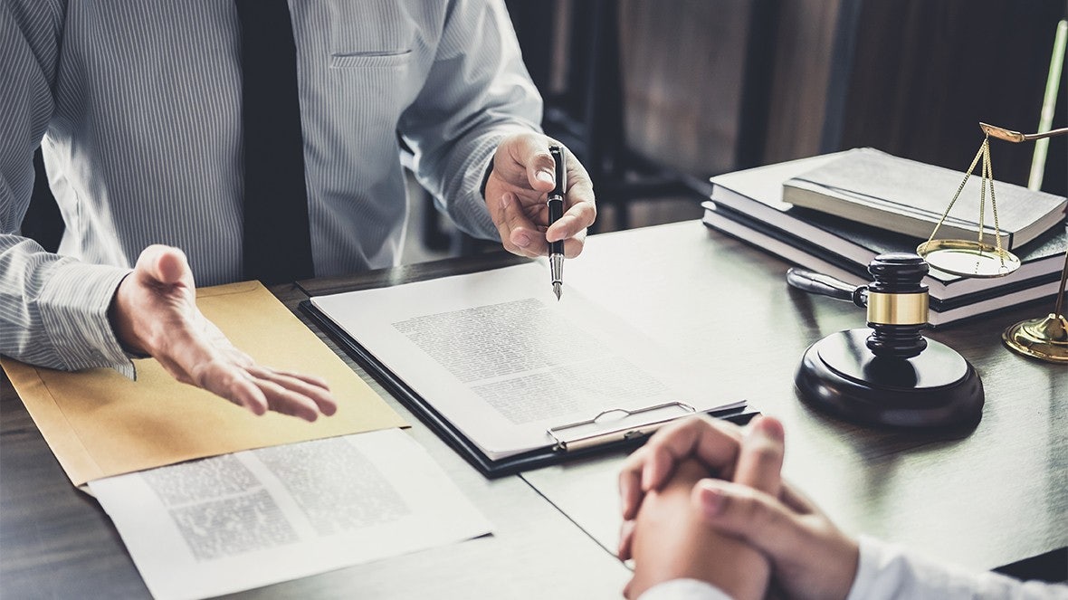 men talking over paperwork