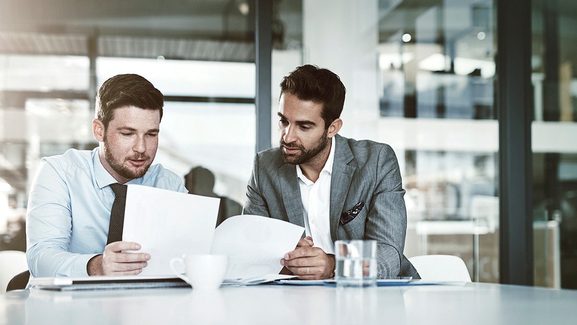 men looking at papers