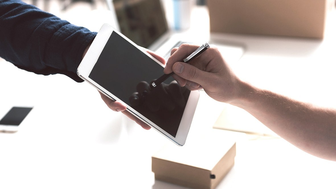 person signing on tablet