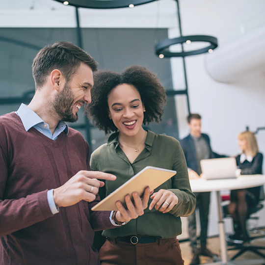 man and women looking at tablet