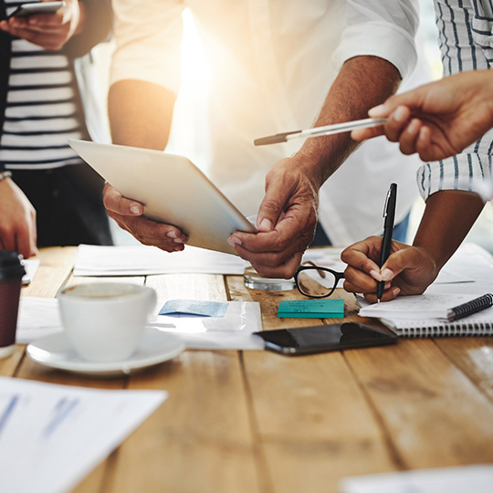 close up of employees working on tablet