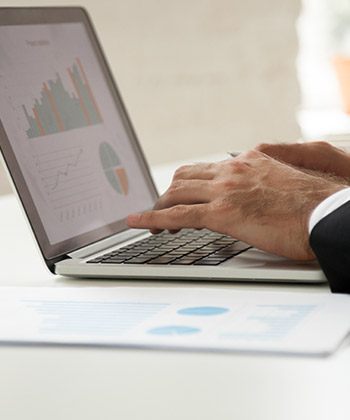 close up of hands typing on a laptop keyboard