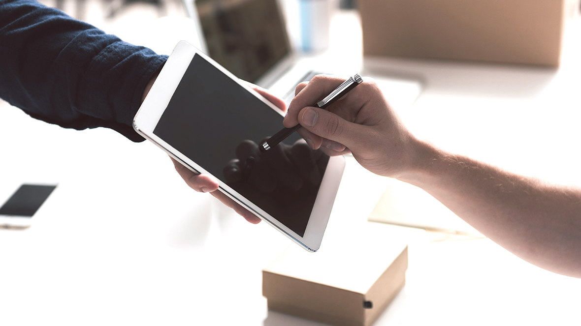 person signing on tablet