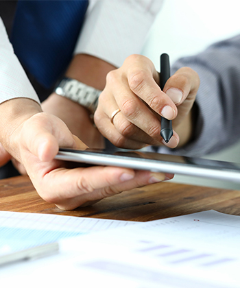 colleagues signing on a tablet