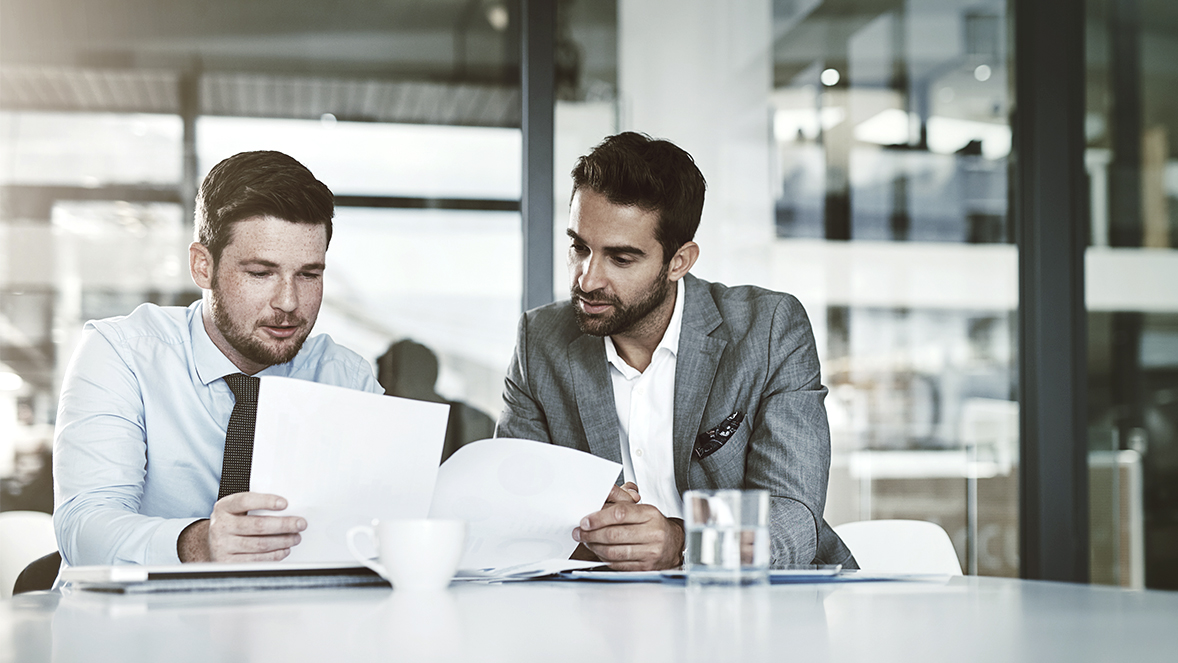 men looking at papers