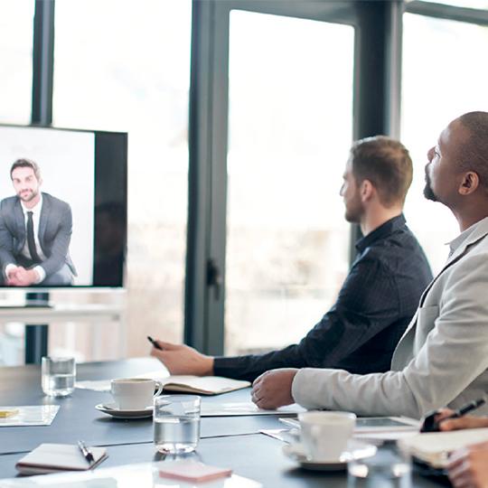 people in a room looking at a screen