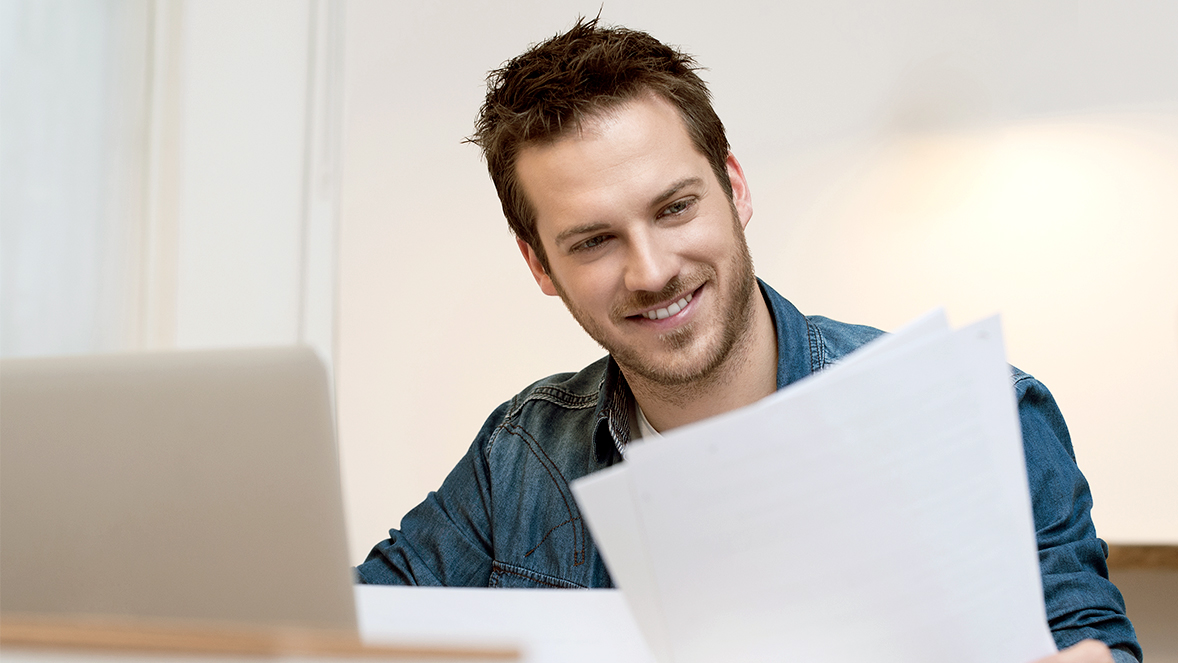 Man looking at sheet of paper