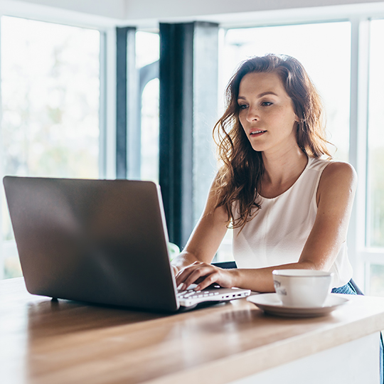 woman typing in a laptop 