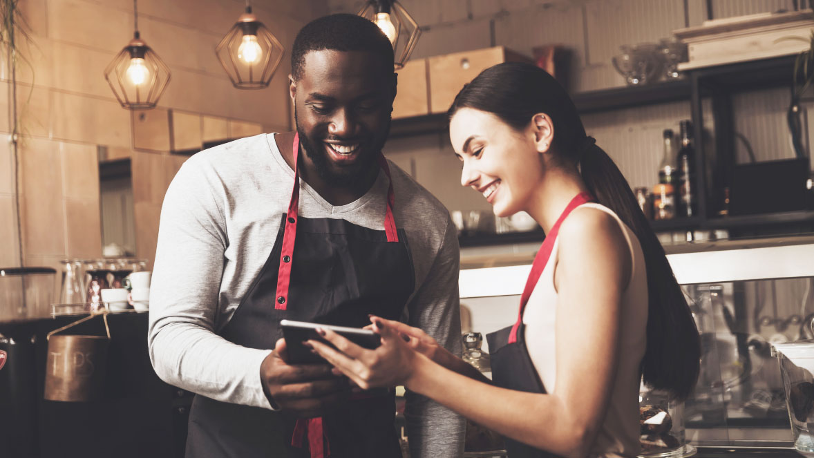 two people looking at a tablet