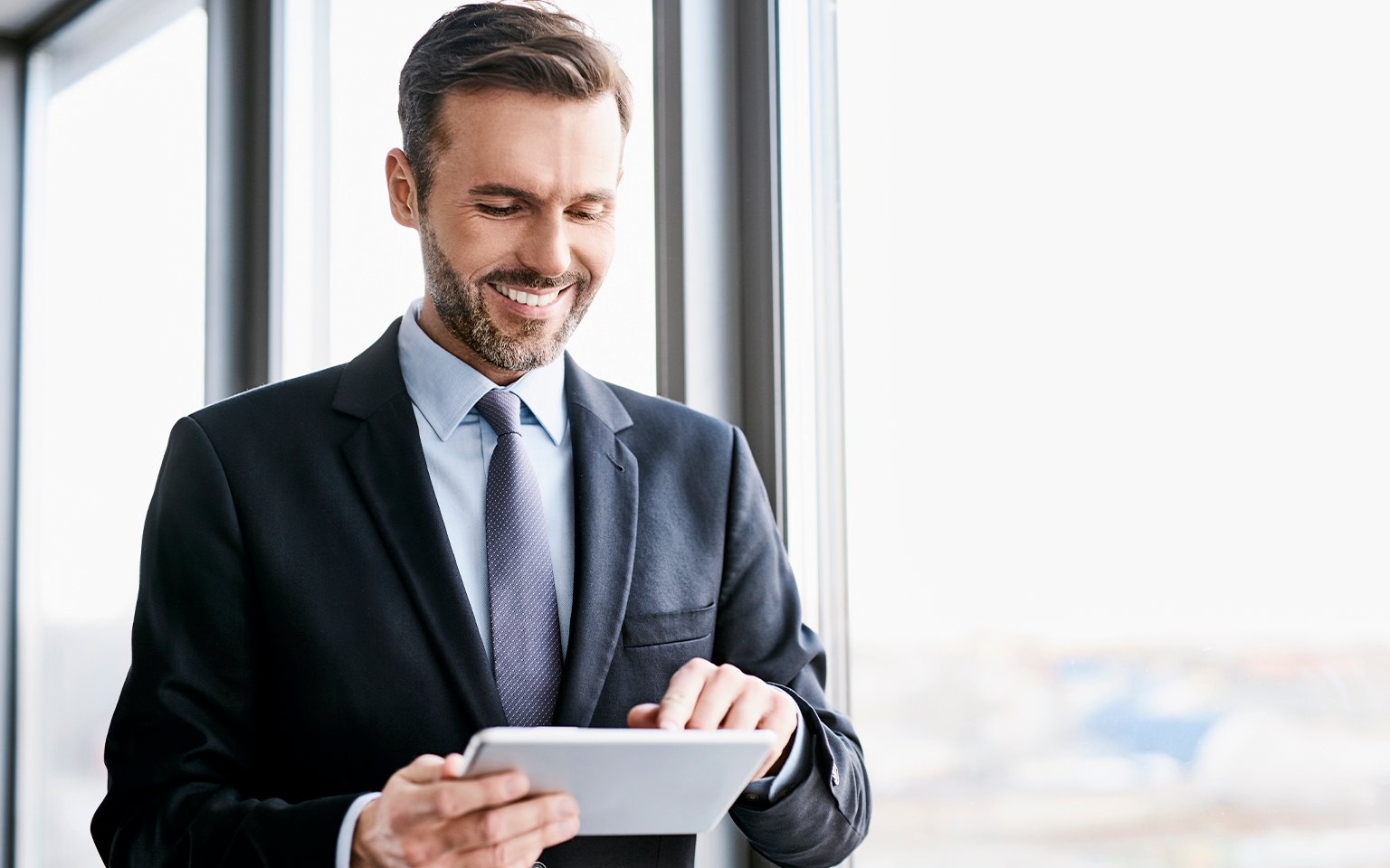 man with finger on tablet