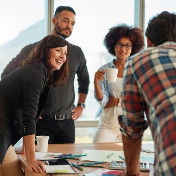 A fulfilling career starts here colleagues laughing in a meeting
