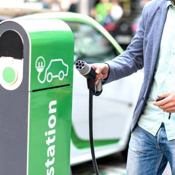 The game-changing charger for electric vehicles man charging car at charging point