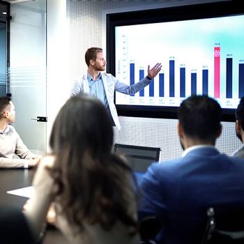 man presenting graph to a group