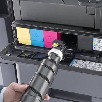 black toner being plugged into a Kyocera printer