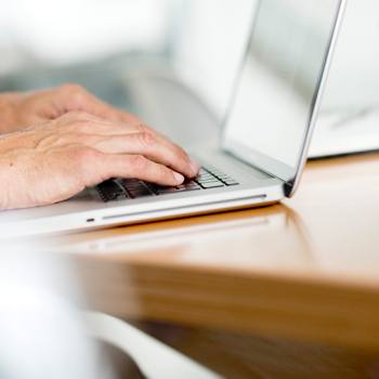What’s happening at Kyocera? close up of hands working on a laptop