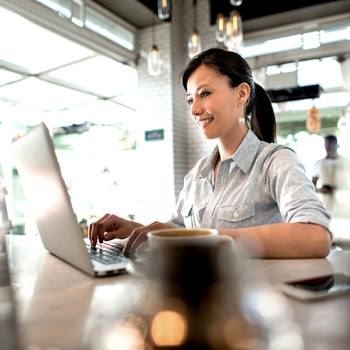 Optimising invoice processing woman working on laptop