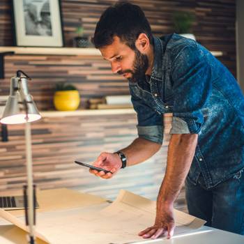 Invest in a capture solution designer taking photos with mobile phone