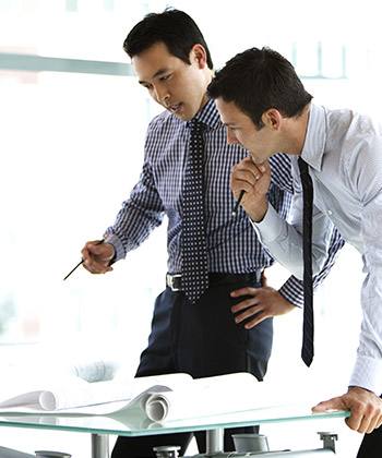 Search for relevant information efficiently two businessman standing over and studying some forms