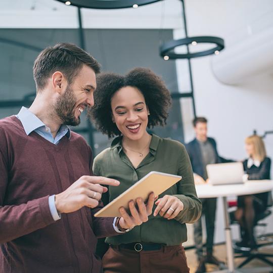 Enterprise Content Management FAQ's man and women looking at tablet