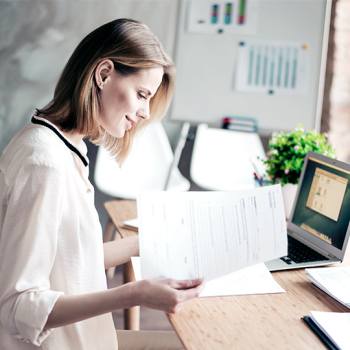 Why sustainability matters when printing in high quantities woman with papers